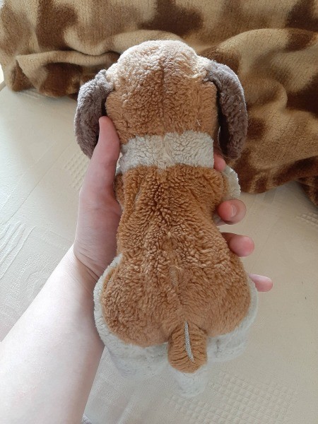 A small brown and white stuffed dog.