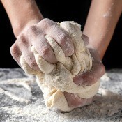 Bread dough being kneaded before baking.