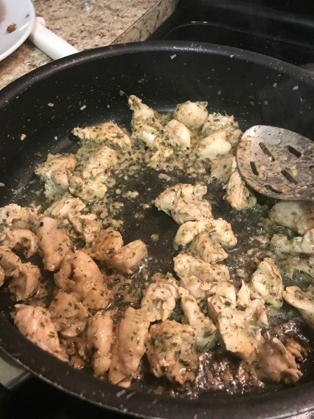 The cooked chicken in a cast iron pan.