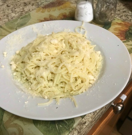 A plate of angel hair pasta, ready to be topped.