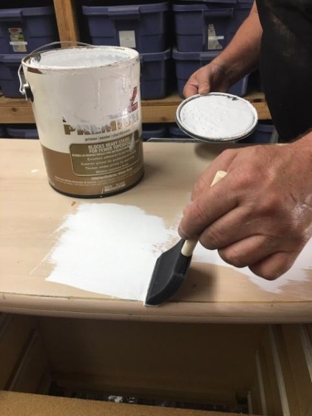 Decalicious Dresser Makeover - applying primer with a foam brush