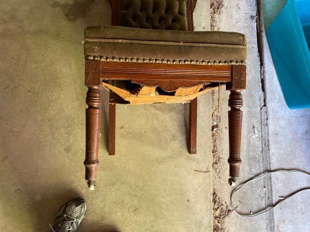 The sagging underside of an antique chair.