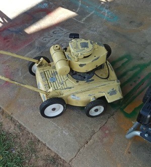 An old yellow lawnmower.