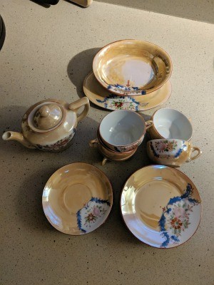 A Japanese tea set with cups, saucers and a teapot.