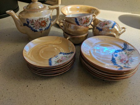 A Japanese tea set with cups, saucers and a teapot.