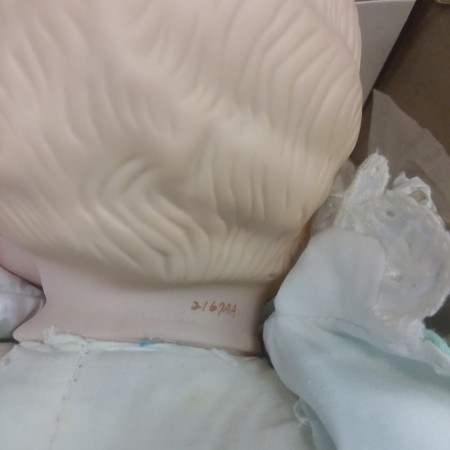 The back of the neck of a porcelain doll.