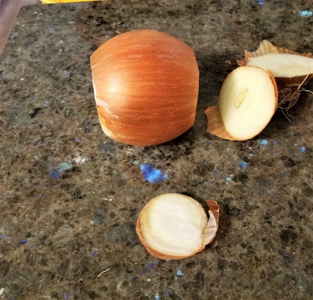Cutting off the two ends of the onion.