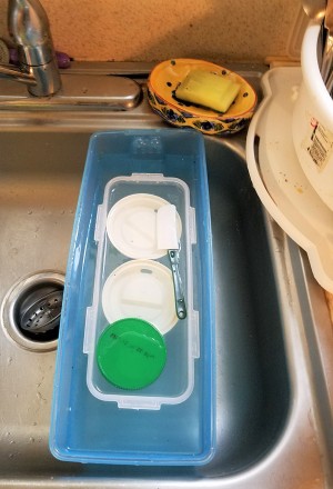 Soaking dishes in bleach water.