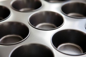 An empty metal muffin tin.