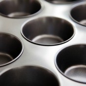 An empty metal muffin tin.