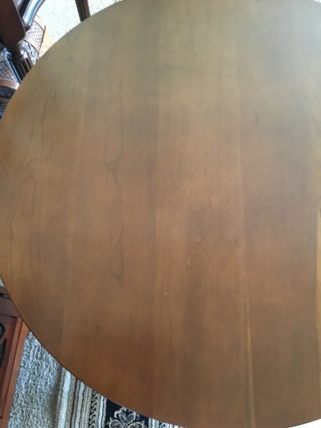 The top of a round wooden table.