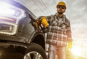 A man standing next to his truck.