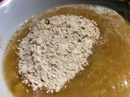 Adding dry ingredient mixture to the wet mixture.