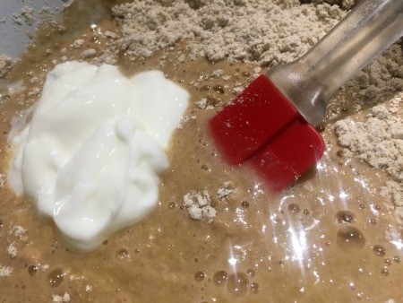 Mixing in the yogurt.