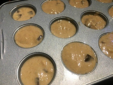 Adding the batter to the muffin tins.
