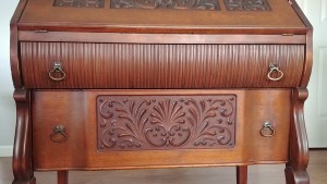 The front of an ornate wooden desk.