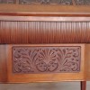 The front of an ornate wooden desk.