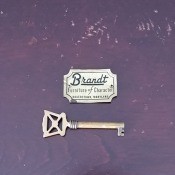 A Brandt plaque next to a key.