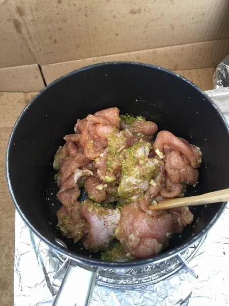 Adding the pork to the lemongrass mixture.