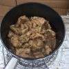 Cooked lemongrass pork in a pot.