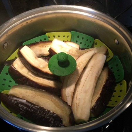 A steamer with eggplant slices.