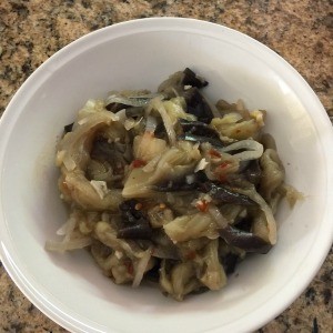 A finished bowl of sauteed eggplant.