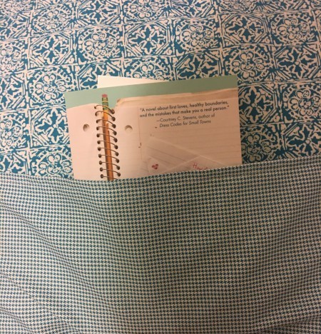 Pocket Pillow - closeup of the blue pattern pocket with a book inside