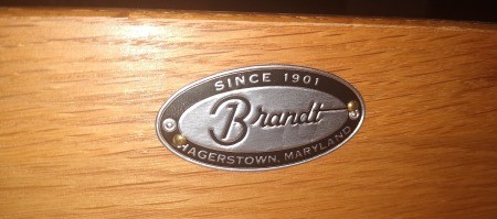 A Brandt marking on a wood dresser.