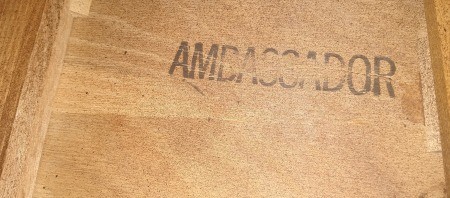 The word "Ambassador" marked on a wood dresser.