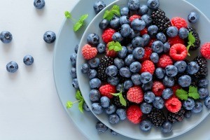 A bowl of fruit salad, with mainly blueberries.