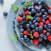 A bowl of fruit salad, with mainly blueberries.