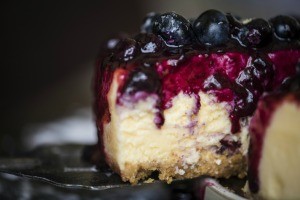 A delicious slice of blueberry cheesecake.
