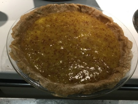 The orange mixture is added to the pie crust.
