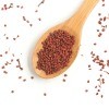 Annatto seeds in a wooden spoon.