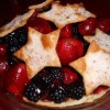 A fruit pie made from strawberries and blackberries, with cut out stars as the crust.