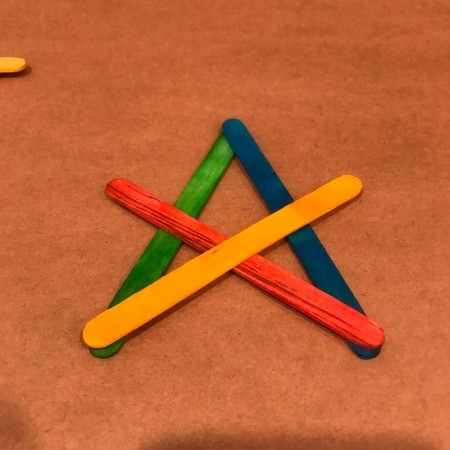4th of July Craft Stick Star with Streamers - adding the next two sticks to form and X