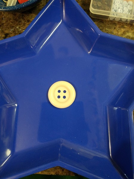 Blue Star Wall Hanging - larger white button in the center of the plastic tray