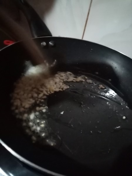 Sauteeing garlic in a pan.