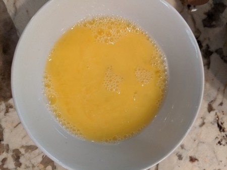 Beaten eggs in a bowl.