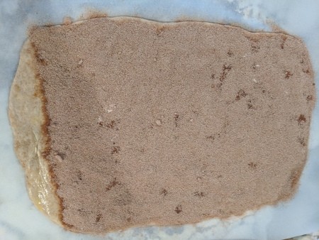 Cinnamon sugar added to the rolled out dough.
