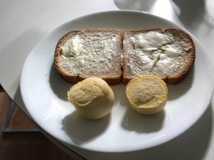 Two egg bites on a plate with toast.