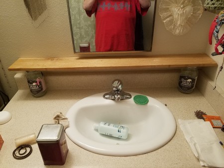 No More Messy Bathroom Shelf - board supported by two glass jars