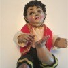 Identifying a Porcelain Figurine? - sitting figurine of a boy with foot up and wearing gold trimmed red vest