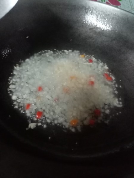 A large frying pan with the chopped vegetables added.