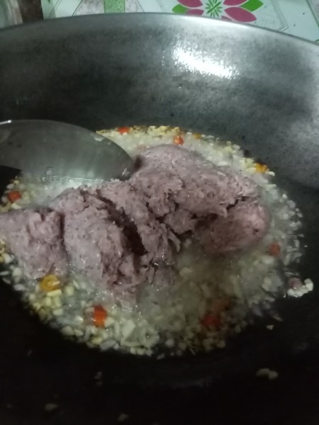 Adding shrimp paste to the mixture.