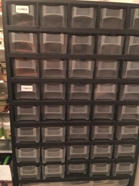 An organizing cabinet with many small plastic drawers.