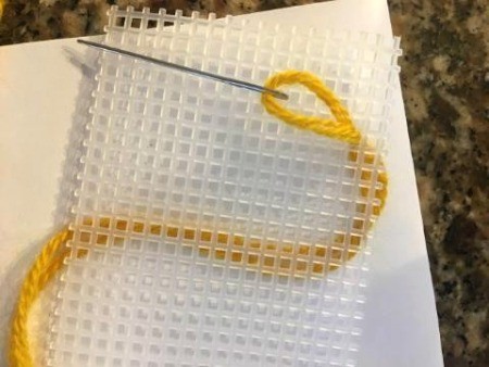 Personalized Needlepoint Bookmarks - yarn threaded needle coming up through a square