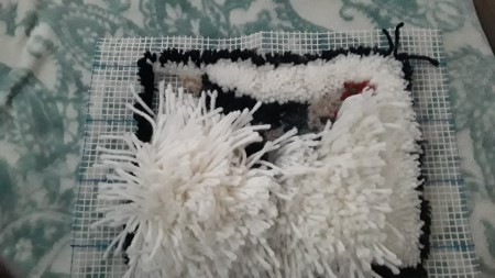 Latch Hook Rug Project Pillow - adding white yarn for background and showing one half trimmed and the other not