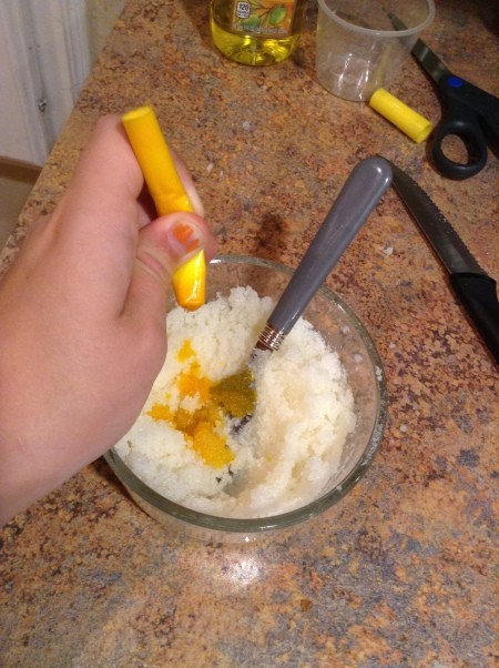 Aromatherapy Body Scrub - squeezing yellow ink into the mixture