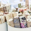 Rolls of wallpaper in containers.